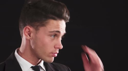 Handsome Man Adjusts Hair in Close-Up Portrait