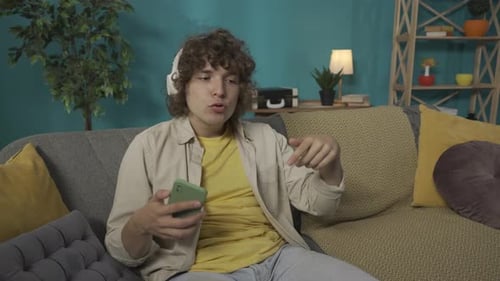 Man Enjoying Music, Singing on the Couch