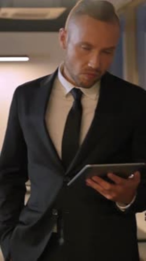 Handsome Businessman with Tablet in Modern Office