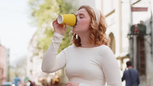 Happy Young Woman Enjoying Drinking Morning Coffee Hot Drink Relaxing Taking a Break in City Street