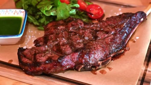 Medium Rare Steak on a Board with Greens