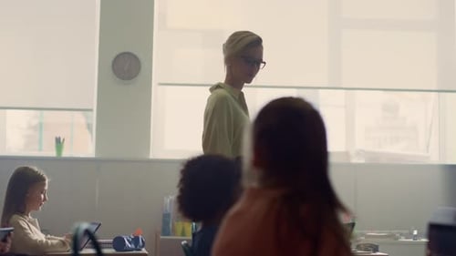 Smart pupils study with digital tablets in modern school classroom slow motion