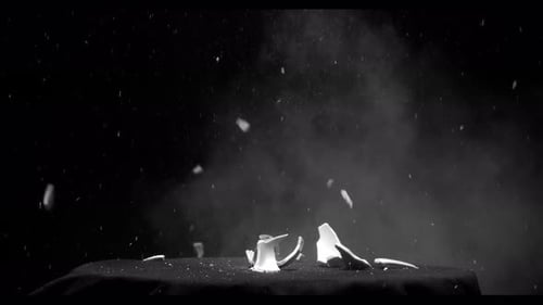 Fragment Collection: Effect of a big ceramic cup breaking from a gun shot over a black background