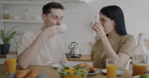 Happy Couple Enjoying Breakfast at Home