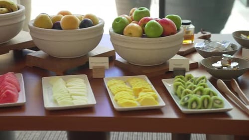Reichhaltiger Frühstücksbrunch, serviert mit großen Schüsseln und Tellern mit Obst, Gemüse und Brot