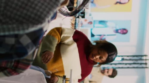 Vertical Video Store Customer Taking Shirt Off of Hangers to Buy Clothes