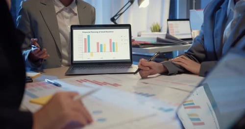Business People Meeting in Urban Workplace at Night