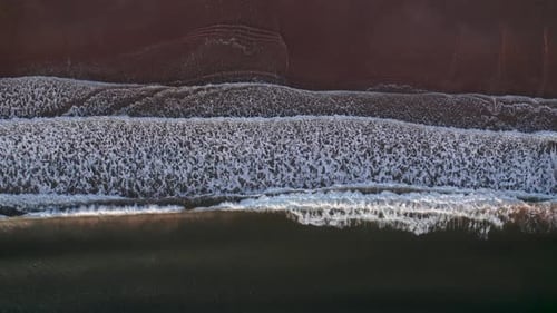 Abstract Top Down Foamy Ocean Waves Breaks Beach
