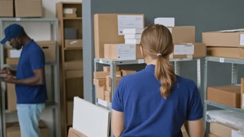 Female Employee Dropping Parcels on Floor while Working at Courier Company