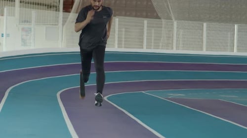 Man with Prosthetic Leg Runs on Track