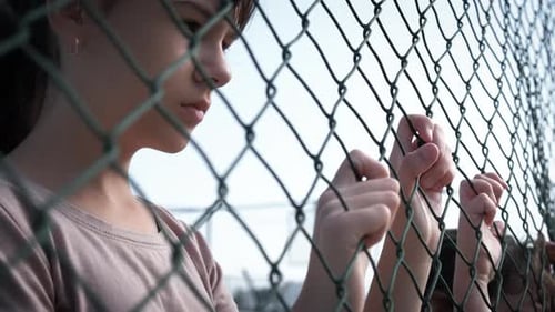 Children Holding Chain Link Fence Close Up
