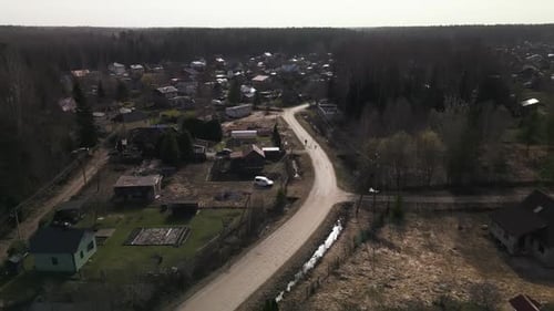 Aerial View of Village Surrounded By Trees Road and Urban Landscape