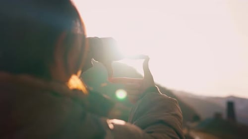 New year planning and vision concept, Close up of woman hands making frame gesture with sunset