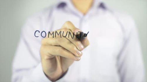 Hand Writing Community on Transparent Glass