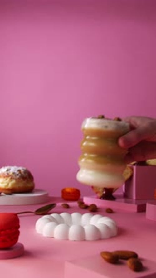 Hand Places Dessert on Colorful Display Table