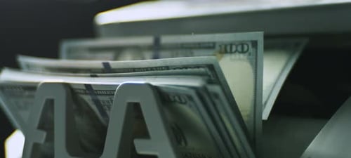 Money Counter Machine Counting Stacks of Hundred Dollar Bills