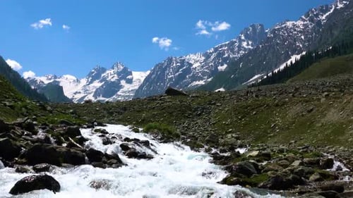 Beautiful mountain scenery. Blue sky, clear river with rocks.