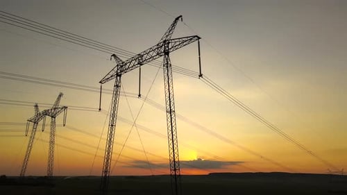 Electricity Pylons Silhouetted Against a Dramatic Sunset