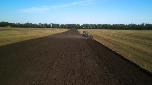 Tractors plowing the field in Ukraine