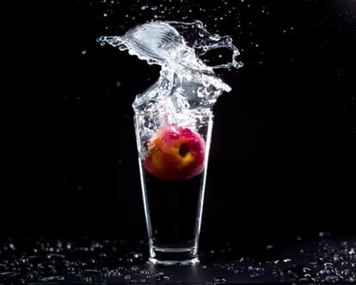 Super Slow Motion of Peaches Pieces Flying Up in the Air with Water Splashes