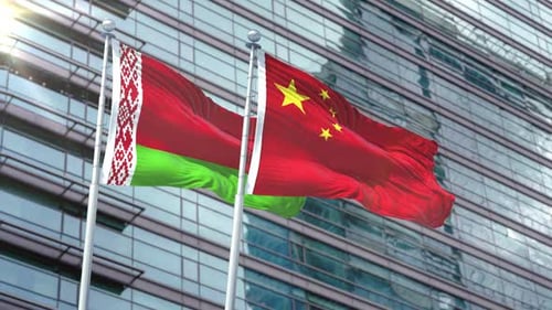 Flags of Belarus and China Waving Against Modern Corporate Building