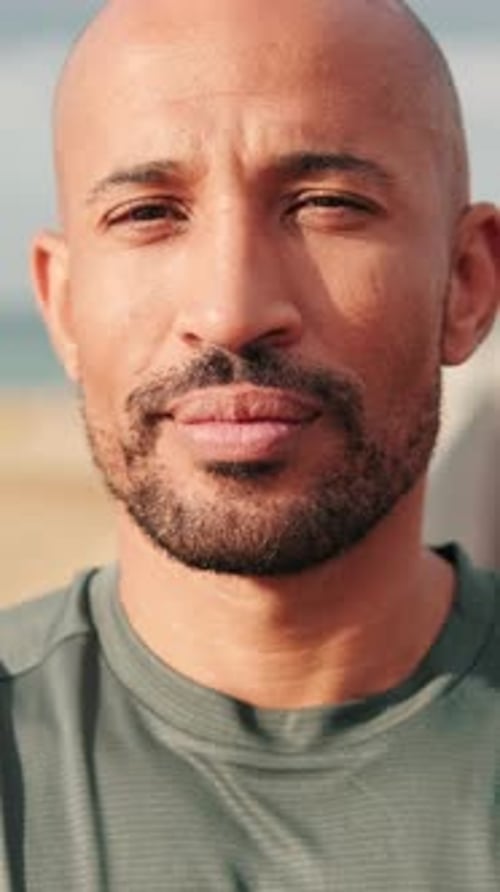 Close-up of confident man against blured background of the sea and sky