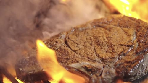 Roast Beef Beef Steak on Grill with Flames Ribeye Steaks Cooking on Flaming Grill A Top Sirloin