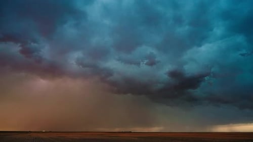 Stormy Sky Over Field at Sunset