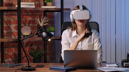 Businesswoman Experiencing Virtual Reality at Office Desk