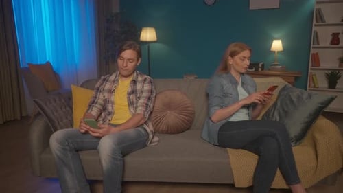 Relationship Problems Conflict A Married Couple Sits on the Couch Turning Their Backs to Each Other