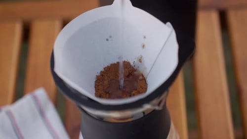 Pouring Water into Coffee Filter for Pour Over