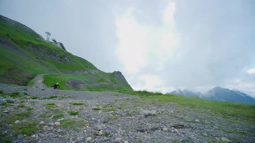 A cyclist is riding a high altitude trail
