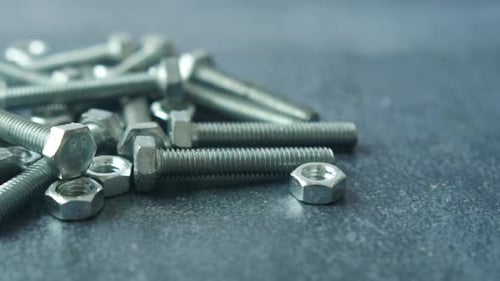 Close-up of Metal Bolts and Nuts on Surface