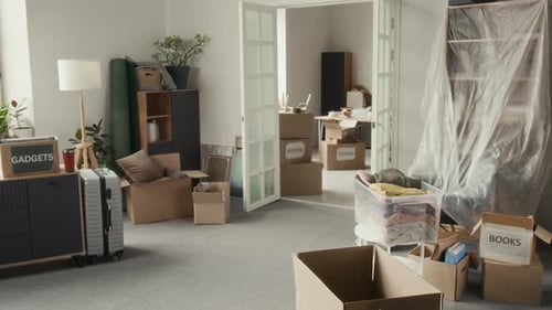 Spacious Room Filled with Cardboard Moving Boxes and Household Items