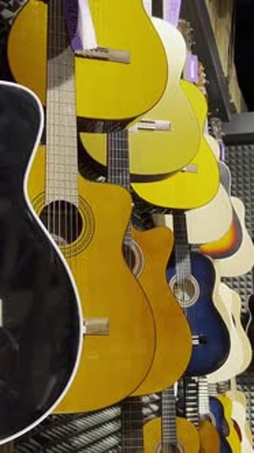 Classical Guitars on Display in an Instrument Store Discounts on Musical Instruments Vertical