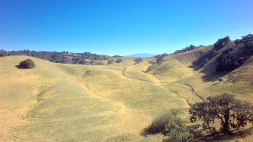 Drone View Of Gorgeous Mountainside Landscape Under Blue Sky 3