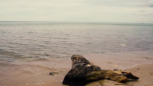A beautiful view by the sea. Sandy beach, sea waves and sky. Slowmotion