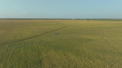 Drone Sprays Crops Over Vast Agricultural Field