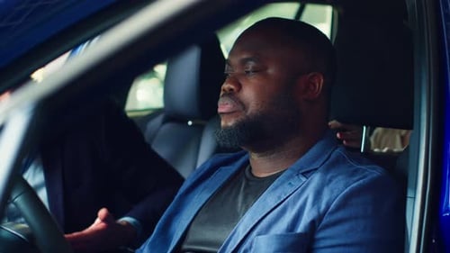 Man Talking About Car in Urban Setting