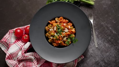 Pasta Dish with Tomato Sauce on Dark Plate