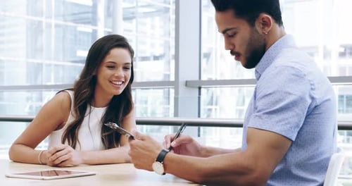 4k video footage of two young business colleagues shaking hands after a meeting