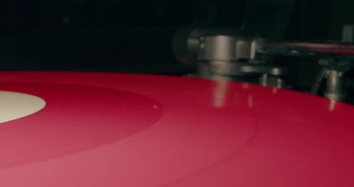 Red Vinyl Record on a Turntable Close Up