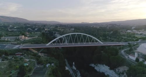 Aerial view of a white bridge at sunset