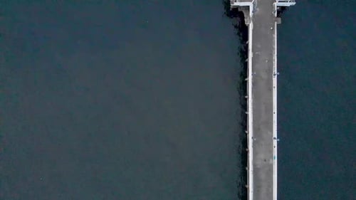 4k Aerial Crane moving Up shot of a Shipping Port Pier on a Sunrise with monsoon clouds covered near