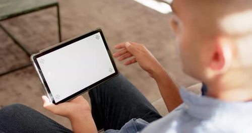 Biracialer Mann tätigt Videoanruf mit Tablet mit Kopierraum auf dem Bildschirm, Zeitlupe