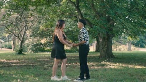 A lesbian Latin proposing in a park to her partner. Celebrate love and diversity. Support for the LG