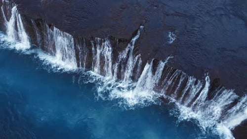 Waterfall in Iceland Snowy Mountain and Cold River in Winter