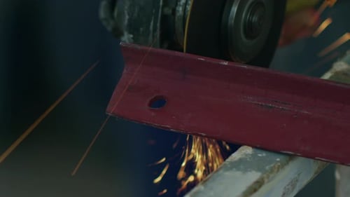 Cutting Metal with Abrasive Saw in Dark Workplace
