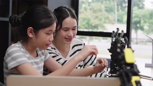 Teenage Girls Working on Robotics Project at Home