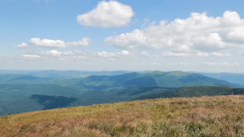 View of the Field Hills and Blue Sky with White Clouds Hiking in the Mountains